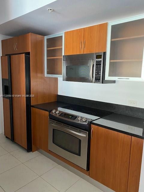 kitchen featuring appliances with stainless steel finishes and light tile patterned flooring