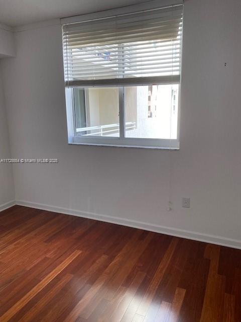 empty room with hardwood / wood-style floors