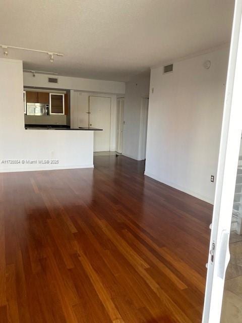 unfurnished living room with dark hardwood / wood-style flooring