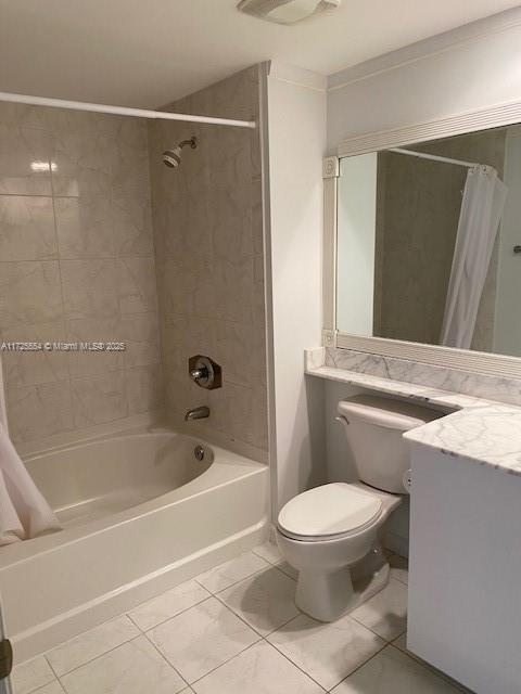 full bathroom with toilet, vanity, shower / tub combo, and tile patterned flooring