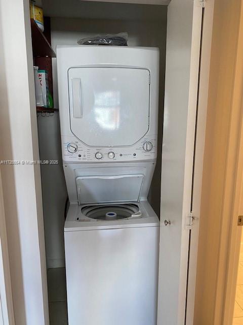 laundry area with stacked washer and clothes dryer