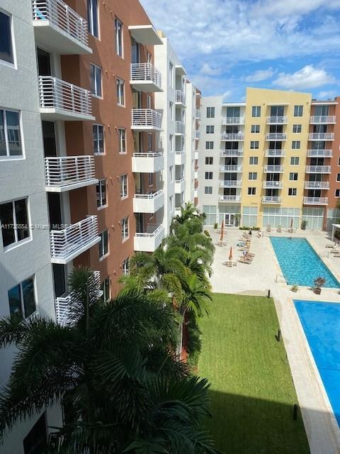 view of building exterior featuring a community pool