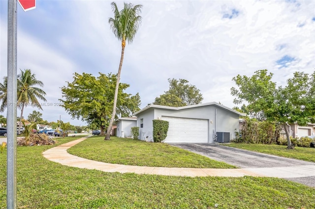 view of home's exterior featuring a garage, cooling unit, and a yard