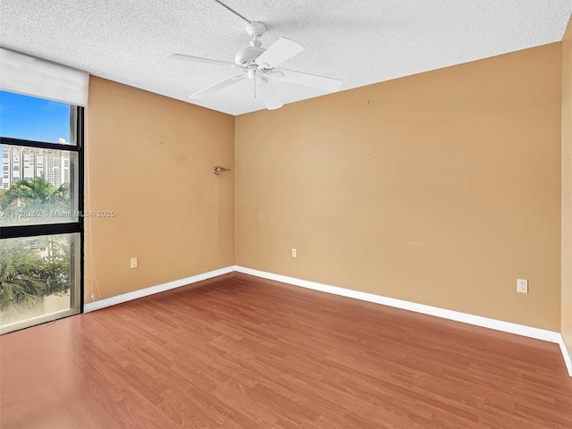 unfurnished room featuring a textured ceiling, ceiling fan, and hardwood / wood-style flooring