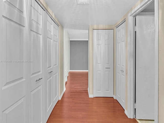 hallway with light hardwood / wood-style flooring