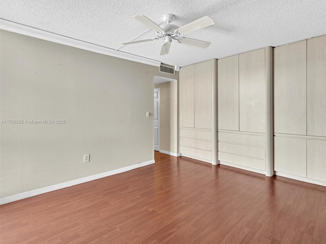 spare room featuring a textured ceiling, ceiling fan, and dark hardwood / wood-style flooring