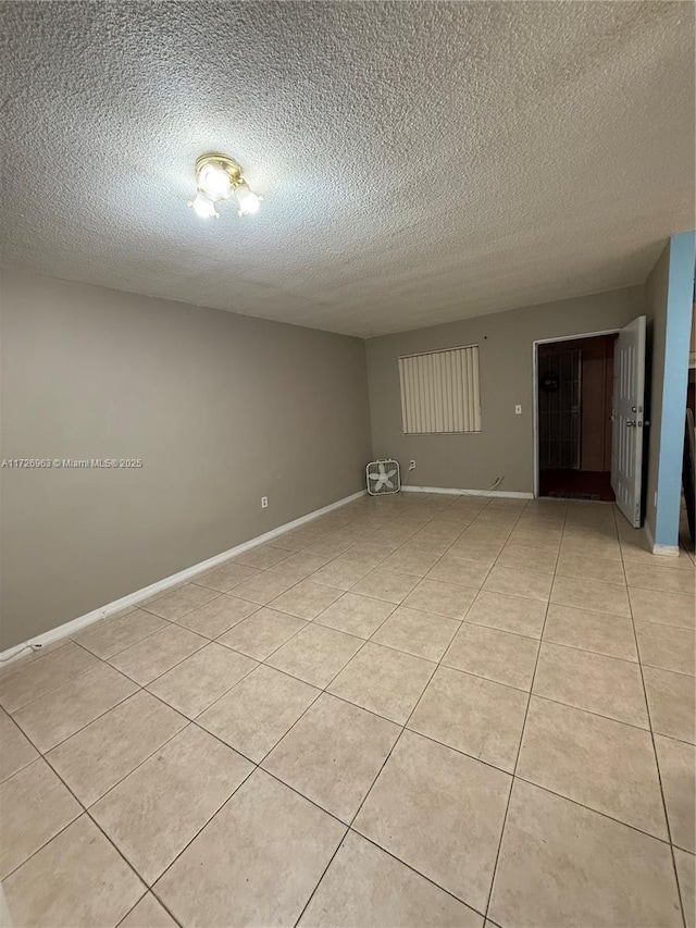 tiled spare room with a textured ceiling