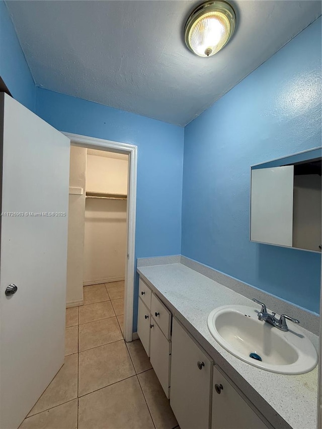 bathroom with vanity and tile patterned flooring