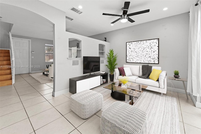 tiled living room with ceiling fan