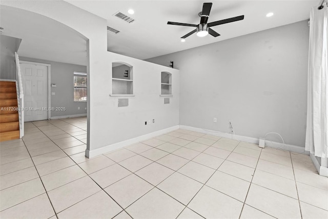 tiled empty room featuring ceiling fan