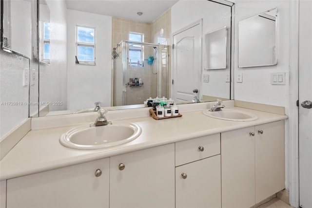 bathroom with a shower with shower door and vanity