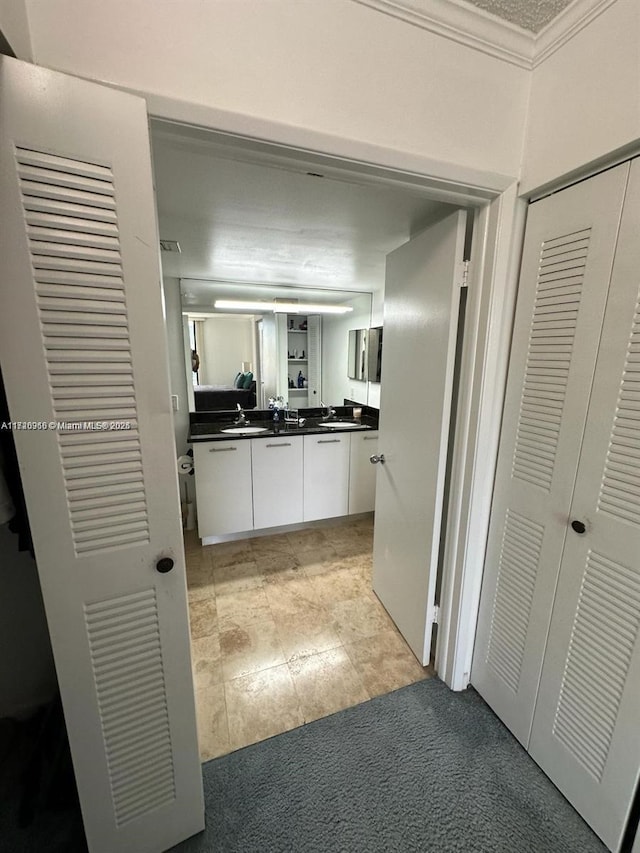 bathroom featuring crown molding and vanity