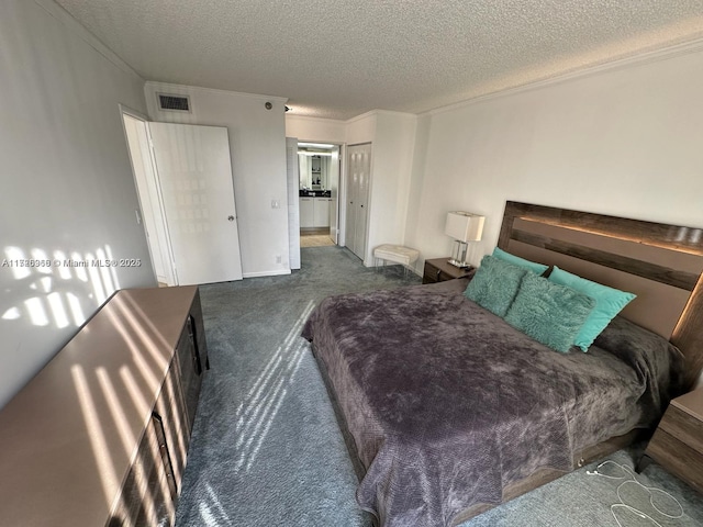 carpeted bedroom with a textured ceiling, a closet, and ornamental molding