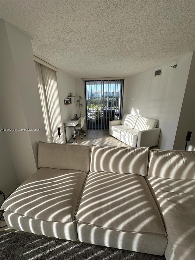 carpeted living room featuring a textured ceiling