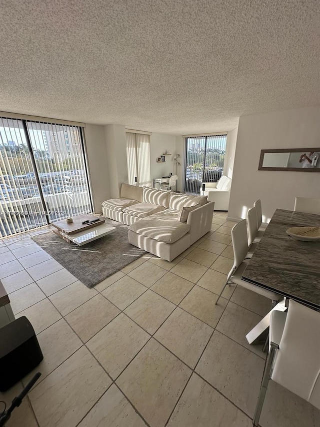 tiled living room featuring a textured ceiling