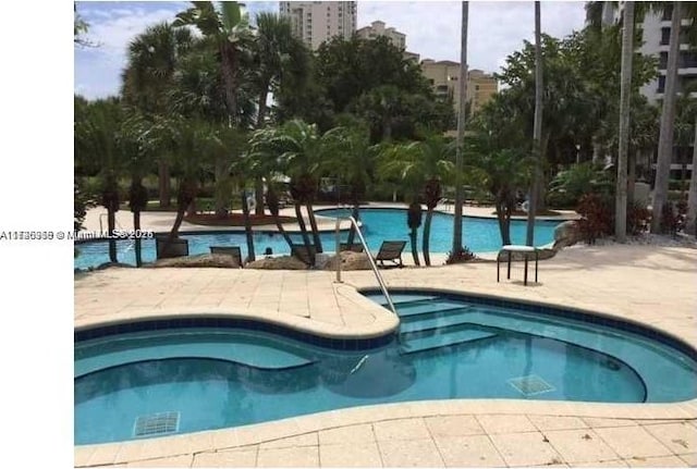 view of swimming pool featuring a patio area