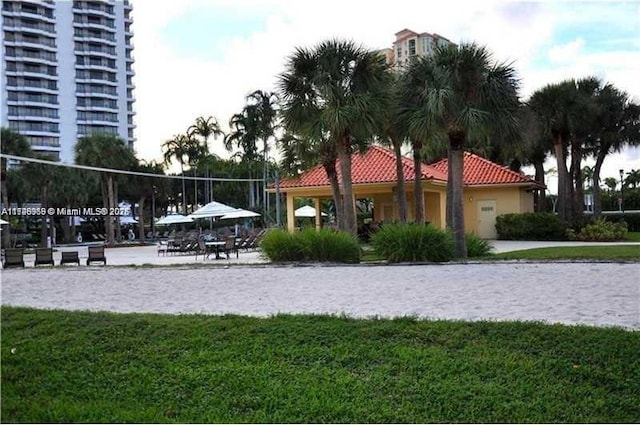 surrounding community featuring a lawn and volleyball court