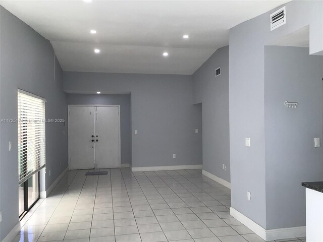 hall featuring light tile patterned flooring