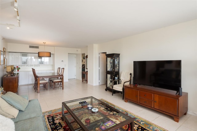 living area featuring visible vents and light tile patterned flooring