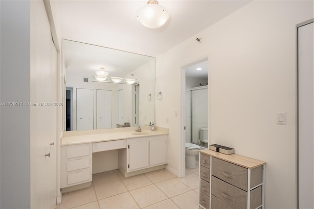 full bathroom with toilet, tile patterned floors, and vanity