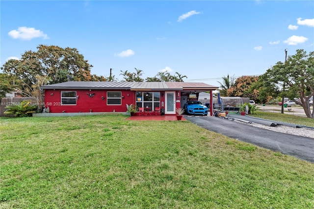 view of front of property with a front lawn and a carport