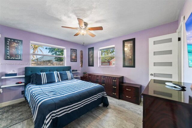 bedroom featuring multiple windows, carpet floors, and ceiling fan