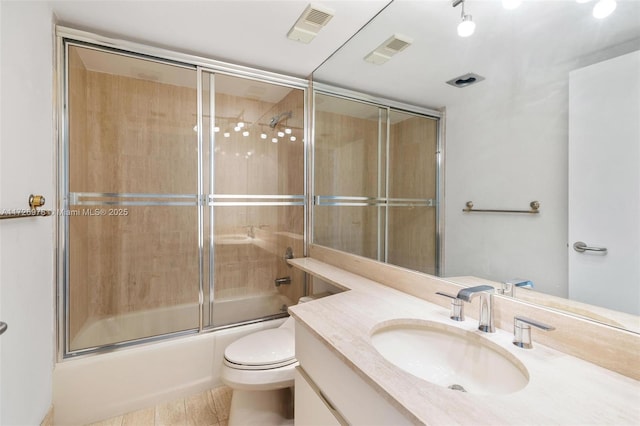 full bathroom featuring toilet, enclosed tub / shower combo, tile patterned flooring, and vanity