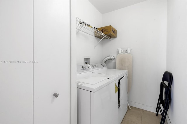 washroom with light tile patterned flooring and washing machine and clothes dryer