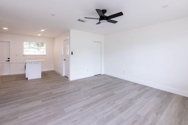 unfurnished room featuring light wood-type flooring and ceiling fan