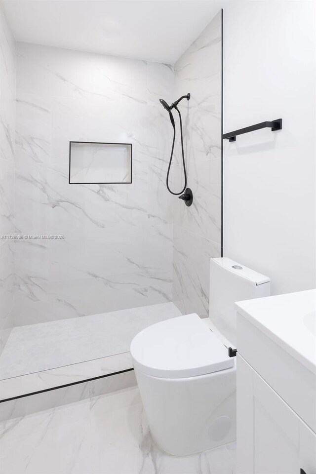 full bathroom featuring a marble finish shower, marble finish floor, vanity, and toilet