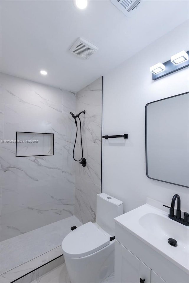 full bath with toilet, a marble finish shower, vanity, and visible vents