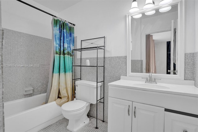 full bathroom featuring toilet, vanity, tile patterned flooring, tile walls, and shower / tub combo