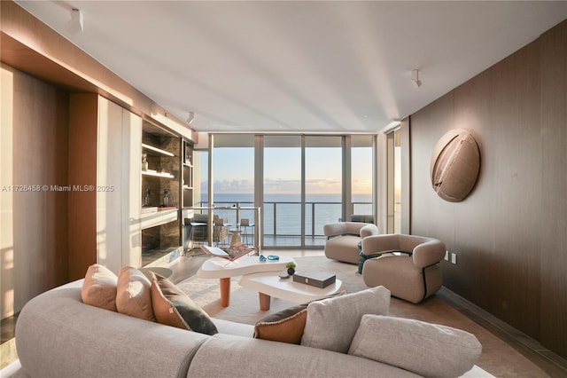 living room with a wall of windows and a water view