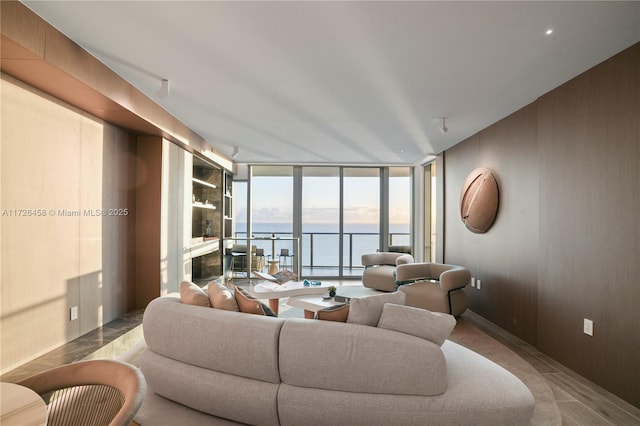 living room with expansive windows and a water view