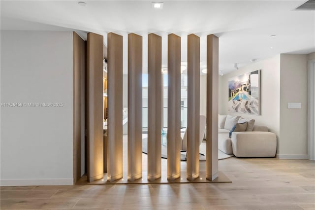 interior space featuring wood finished floors, visible vents, and baseboards