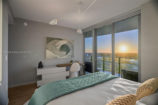 bedroom featuring access to exterior, wood tiled floor, and baseboards