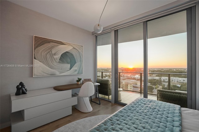 bedroom featuring access to exterior and wood finished floors