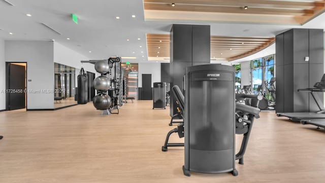 workout area featuring recessed lighting and light wood-style flooring