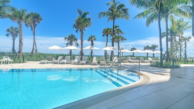 pool featuring a patio and fence