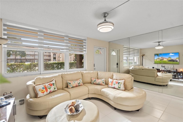 tiled living room with a textured ceiling