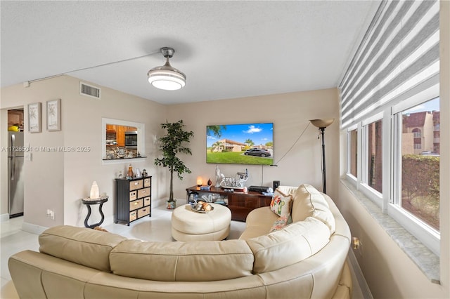 tiled living room with a textured ceiling