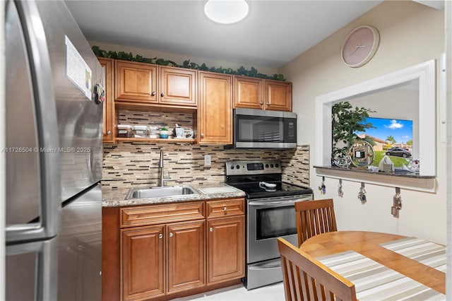 kitchen with backsplash, sink, appliances with stainless steel finishes, light tile patterned floors, and light stone counters