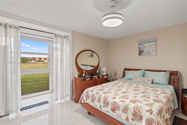 tiled bedroom with a textured ceiling