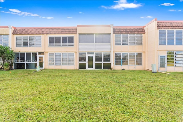 rear view of property featuring a yard