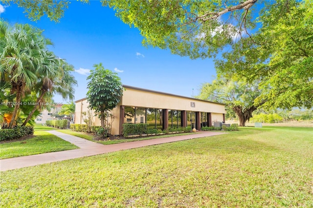 view of front of house with a front lawn and central air condition unit