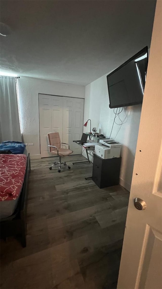 bedroom featuring a closet and dark hardwood / wood-style floors