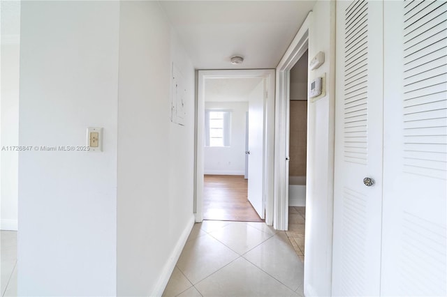 hall with light tile patterned floors