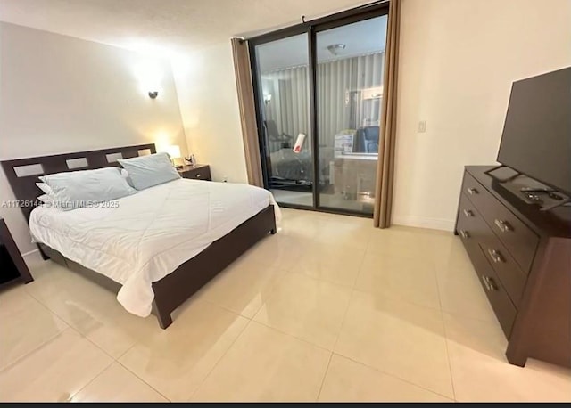 1621 Collins Ave Unit 310, Miami Beach, FL 33139 - bedroom featuring access to outside, baseboards, and light tile patterned floors