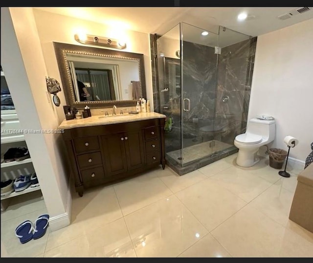 1621 Collins Ave Unit 310, Miami Beach, FL 33139 - full bath with visible vents, a stall shower, vanity, tile patterned floors, and toilet