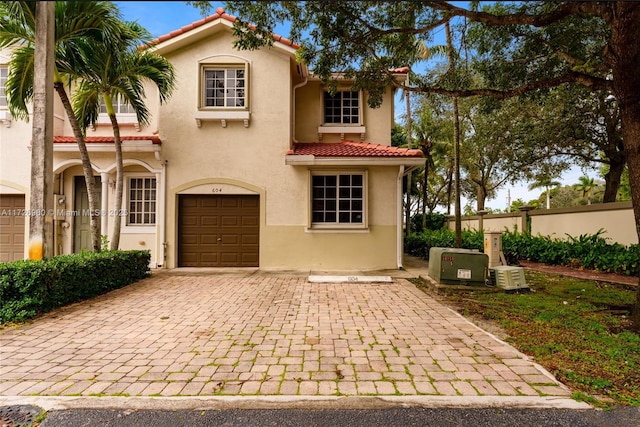 mediterranean / spanish house featuring a garage